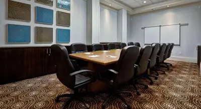a conference room with a wooden table and chairs at Niagara Fallsview Hotel in Niagara Falls