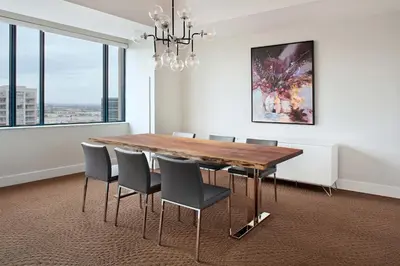 a dining room with a wooden table and chairs at Sheraton Parkway Toronto North Hotel & Suites in Richmond Hill