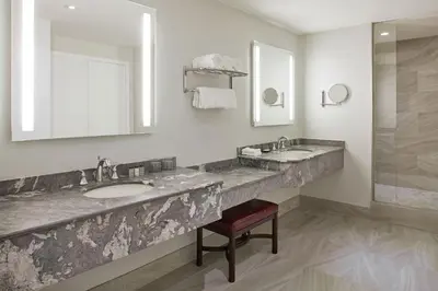 a bathroom with two sinks and a mirror at Sheraton Parkway Toronto North Hotel & Suites in Richmond Hill