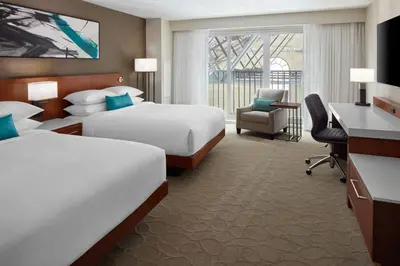 a hotel room with two beds and a desk at Delta Hotels by Marriott London Armouries in London