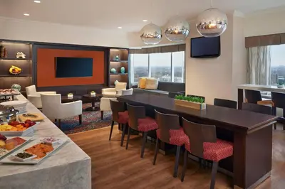 a dining room and living room in a hotel room at Delta Hotels by Marriott London Armouries in London