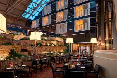 a restaurant with tables and chairs in a building at Delta Hotels by Marriott London Armouries in London