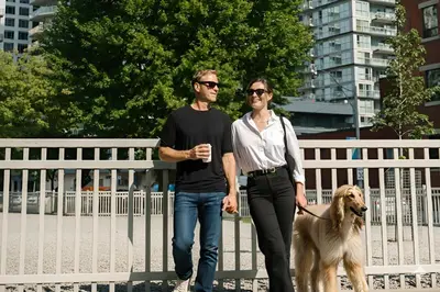 a man and a woman walking a dog at SoHo Hotel Toronto in Toronto