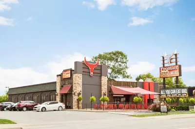 a restaurant with cars parked in a parking lot at Days Inn by Wyndham Fallsview in Niagara Falls