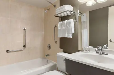 a bathroom with a sink and a toilet and a bath tub at Days Inn by Wyndham Fallsview in Niagara Falls