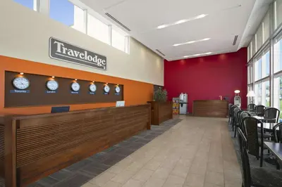 a waiting room with clocks on the wall at Travelodge by Wyndham Richmond Hill in Richmond Hill