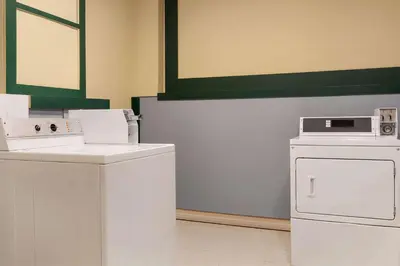 a laundry room with washer and dryer at Travelodge by Wyndham Richmond Hill in Richmond Hill