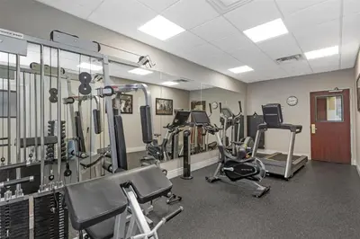 a gym with treadmills and ellipticals in a room at Best Western Plus Travel Hotel Toronto Airport in Toronto