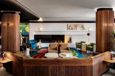 a large living room with a large couch and a fireplace at The Drake Hotel in Toronto