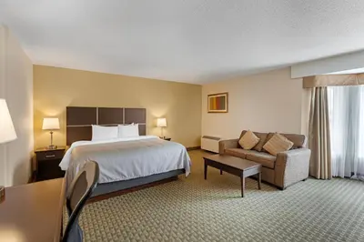 a hotel room with a bed and a couch at Quality Inn & Suites in Brampton