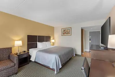 a hotel room with a bed and a couch at Quality Inn & Suites in Brampton