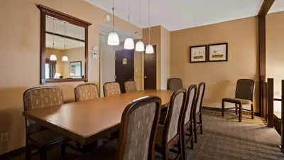 a conference room with a wooden table and chairs at Best Western Plus Lamplighter Inn & Conference Centre in London