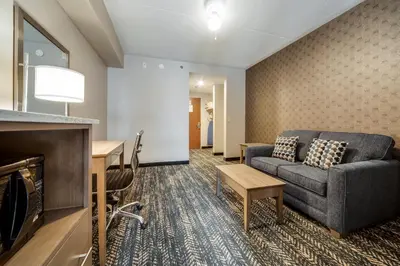 a living room with a couch and a table at Monte Carlo Inn Brampton in Brampton