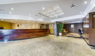 a lobby with a bar in the middle of it at Monte Carlo Inn Airport Suites in Mississauga