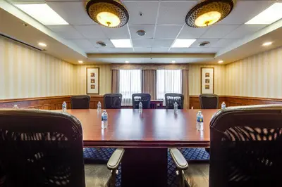 a conference room with a long table and chairs at Monte Carlo Inn Airport Suites in Mississauga
