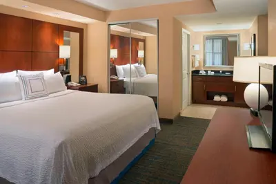 a hotel room with a large bed and a bathroom at Residence Inn by Marriott Toronto Downtown / Entertainment District in Toronto