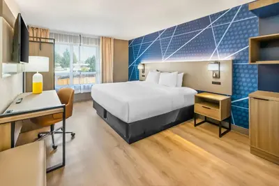 a hotel room with a bed and a desk at Comfort Inn in London
