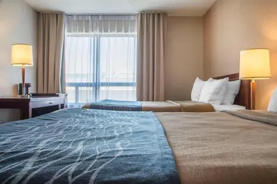 a hotel room with two beds and a window at Comfort Inn in London