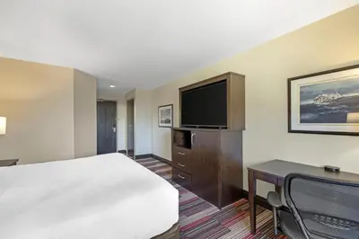 a hotel room with a bed and a flat screen tv at Best Western Plus Stoneridge Inn & Conference Centre London Ontario in London