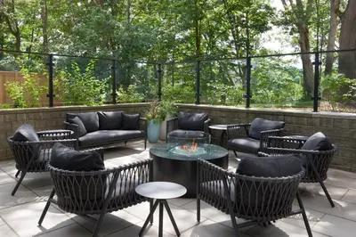 a patio with chairs and a table with a fire pit at TownePlace Suites by Marriott Toronto Oakville in Oakville