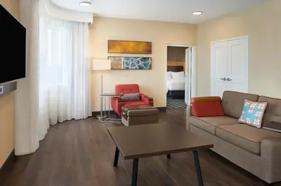 a living room with a couch and a table at TownePlace Suites by Marriott Toronto Oakville in Oakville