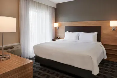 a bedroom with a large white bed and a desk at TownePlace Suites by Marriott Toronto Oakville in Oakville