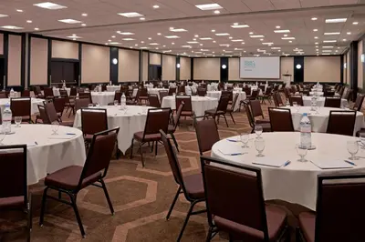 a conference room with white tables and chairs at Four Points by Sheraton Toronto Airport in Mississauga