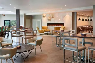 a restaurant with tables and chairs at Four Points by Sheraton Toronto Airport in Mississauga