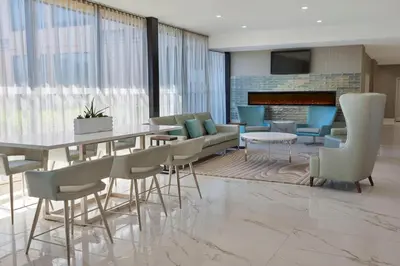 a dining room with a table and chairs and a fireplace at Four Points by Sheraton Toronto Airport in Mississauga