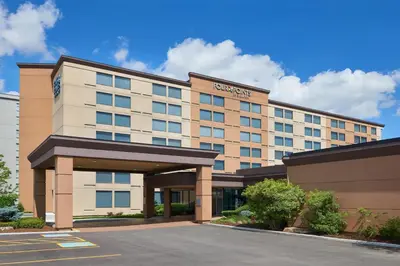 a hotel building with a parking lot in front of it at Four Points by Sheraton Toronto Airport in Mississauga