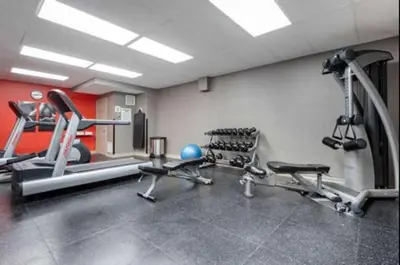 a gym with several tread machines in a room at Quality Inn & Suites Oakville-Mississauga in Oakville