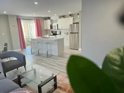 a kitchen and living room with a couch and a table at ENTIRE 2 BEDROOM APARTMENT DOWNTOWN - u2 in Kitchener