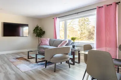 a living room with a couch and a table at ENTIRE 2 BEDROOM APARTMENT DOWNTOWN - u2 in Kitchener