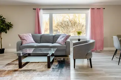 a living room with a couch and a chair at ENTIRE 2 BEDROOM APARTMENT DOWNTOWN - u2 in Kitchener