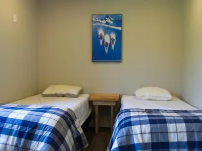 two beds in a room with a picture on the wall at 6BR Blue Mountain Chalet Hot Tub Updated Walk to Village Fun in Blue Mountains