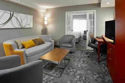a living room with a couch and a table at Courtyard by Marriott Toronto Brampton in Brampton