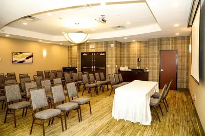 a conference room with a white table and chairs at Courtyard by Marriott Toronto Brampton in Brampton