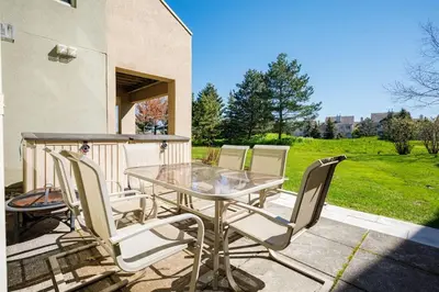 a glass table and chairs on a patio at Wintergreen Haven 85574 in Blue Mountains