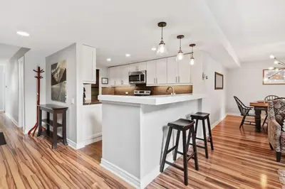 a kitchen and dining room with a counter and stools at All Seasons Sierra Lane Retreat 88371 in Blue Mountains