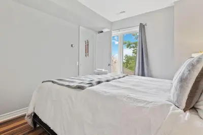 a white bedroom with a large bed and a window at All Seasons Sierra Lane Retreat 88371 in Blue Mountains