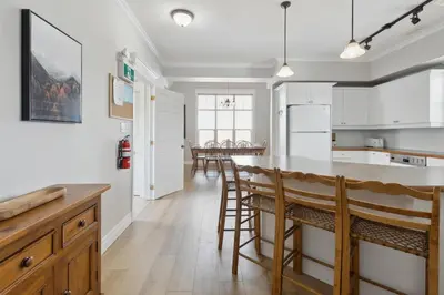 a kitchen with white cabinets and a wooden counter top at 3BR Snowbridge Chalet in Blue with Golf Course View in Collingwood