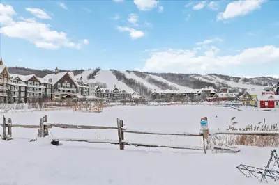 a town in the snow with a fence at Modern Mountainside Ski in Ski out 87111 in Blue Mountains