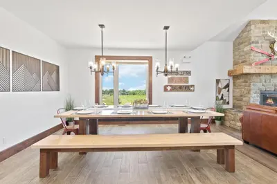 a dining room with a table and a fireplace at Luxurious Arlberg Retreat 89883 in Blue Mountains