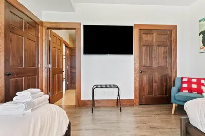 a room with two beds and a flat screen tv at Luxurious Arlberg Retreat 89883 in Blue Mountains