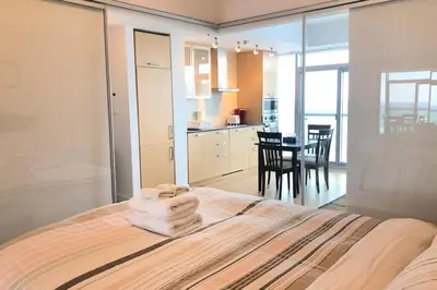 a bedroom with a bed with towels on top of it at Magnificient View next CN Tower/Rogers/Union/MTCC in Toronto