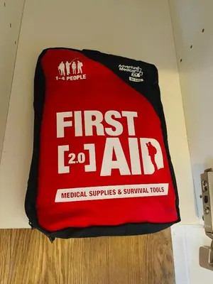 a red first aid bag sitting on a wall at MT house in Mississauga