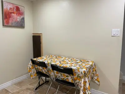 a table with a flowered table cloth on it at MT house in Mississauga