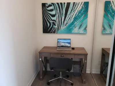 a desk with a laptop computer on top of it at Luxurious Condo Apartment 1BR-1BA-1Office free parking in Brampton