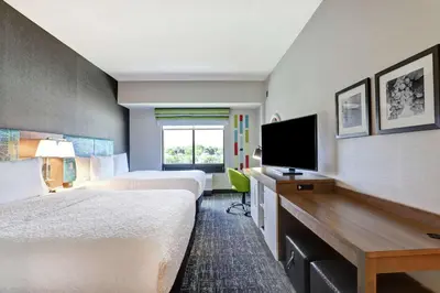 a hotel room with two beds and a flat screen tv at Hampton Inn St. Catharines Niagara in St. Catharines