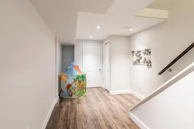 a hallway with a staircase with a bag on the floor at GlobalStay 3 Bedroom Townhome with Hot Tub Hamilton in Hamilton